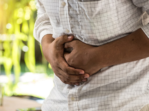 A man with abdominal pain coming from a gallbladder attack. Learn more about the causes and other symptoms related to gallbladder attacks. Article by The Surgical Clinic in Nashville, Tennessee.