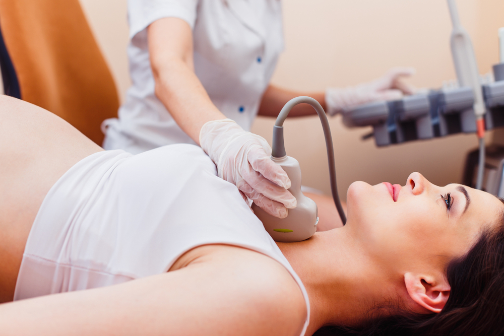 Professional,Doctor,Screening,Of,Pregnant,Woman,By,Ultrasound.,Thyroid,Gland A pregnant woman getting her thyroid checked.