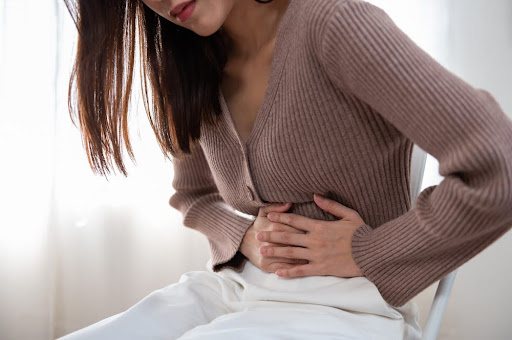Woman with stomach cancer pain