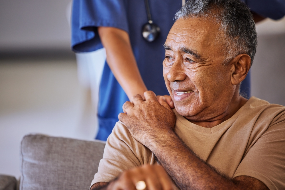 Older man smiling with nurse