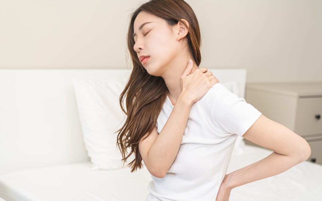 Woman sitting down with neck pain.