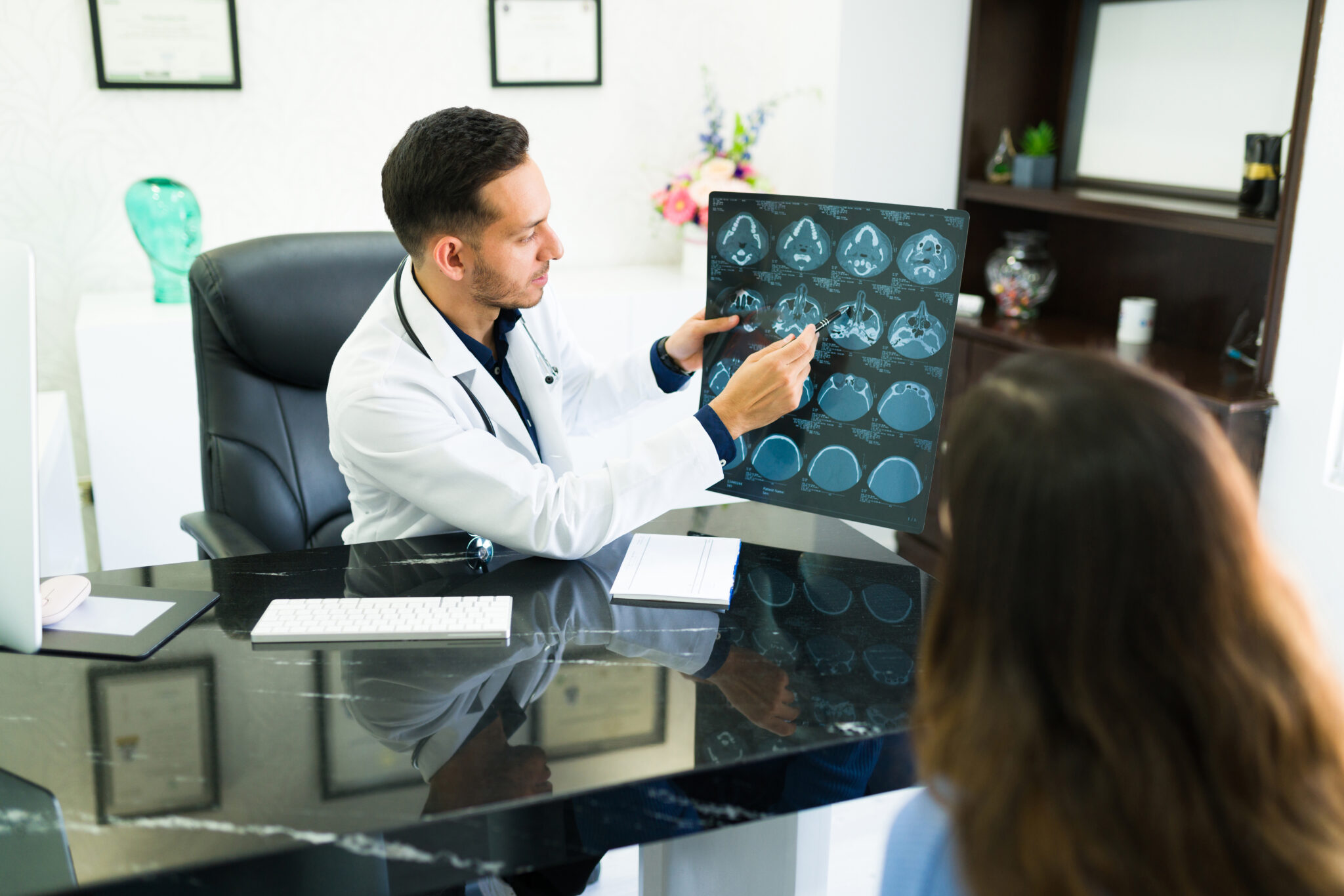 Doctor reviewing medical images/scans with patient.