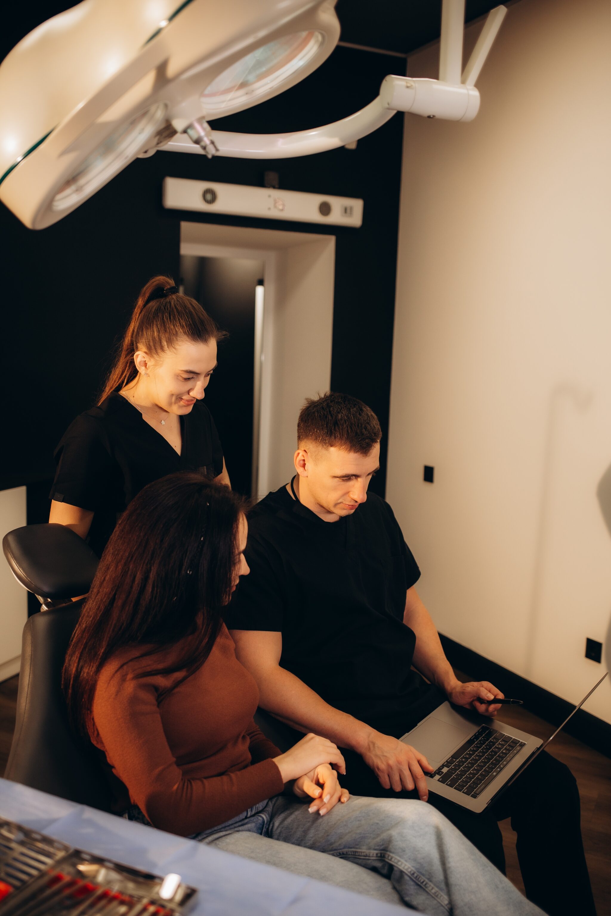 Doctor reviewing medical images/scan with patient and nurse.