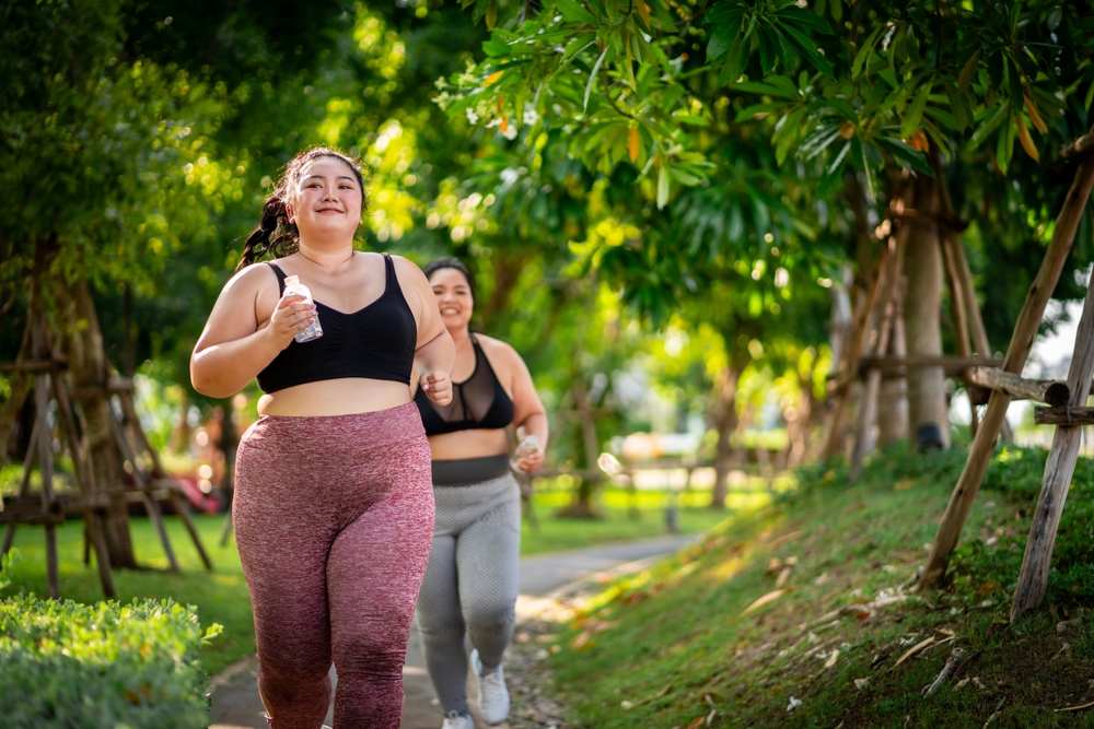 Two women jogging along a path