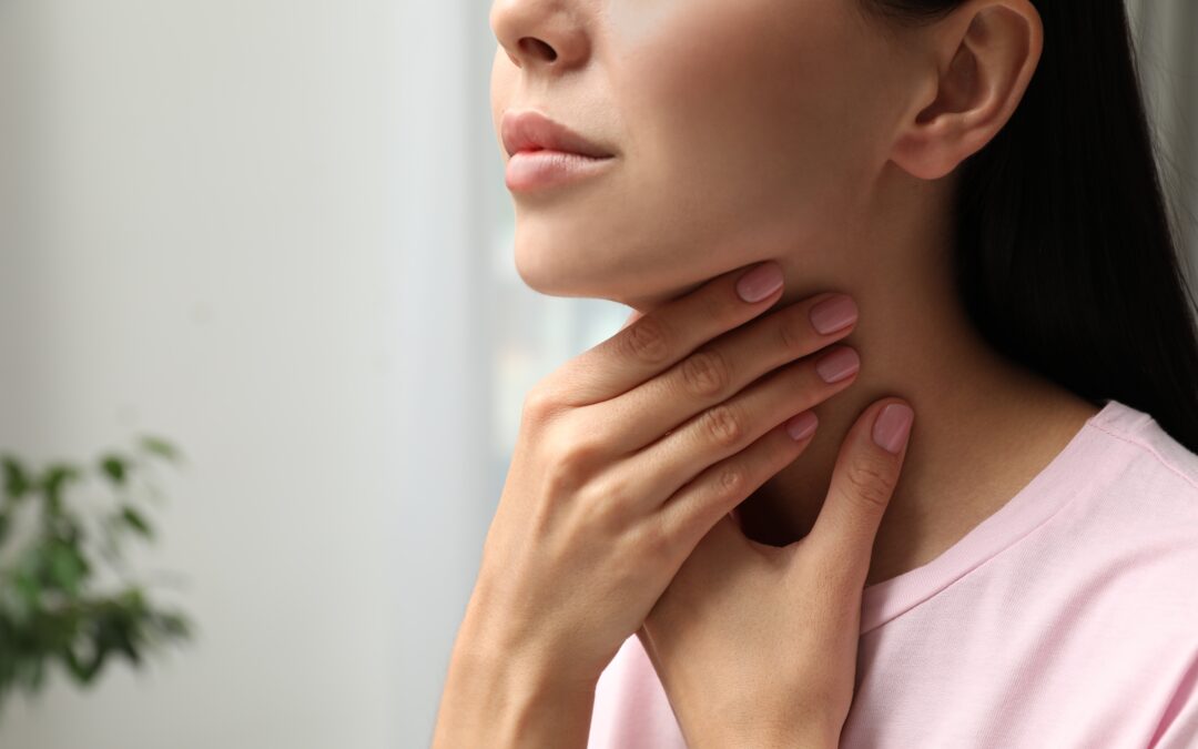 Woman checking her own thyroids.