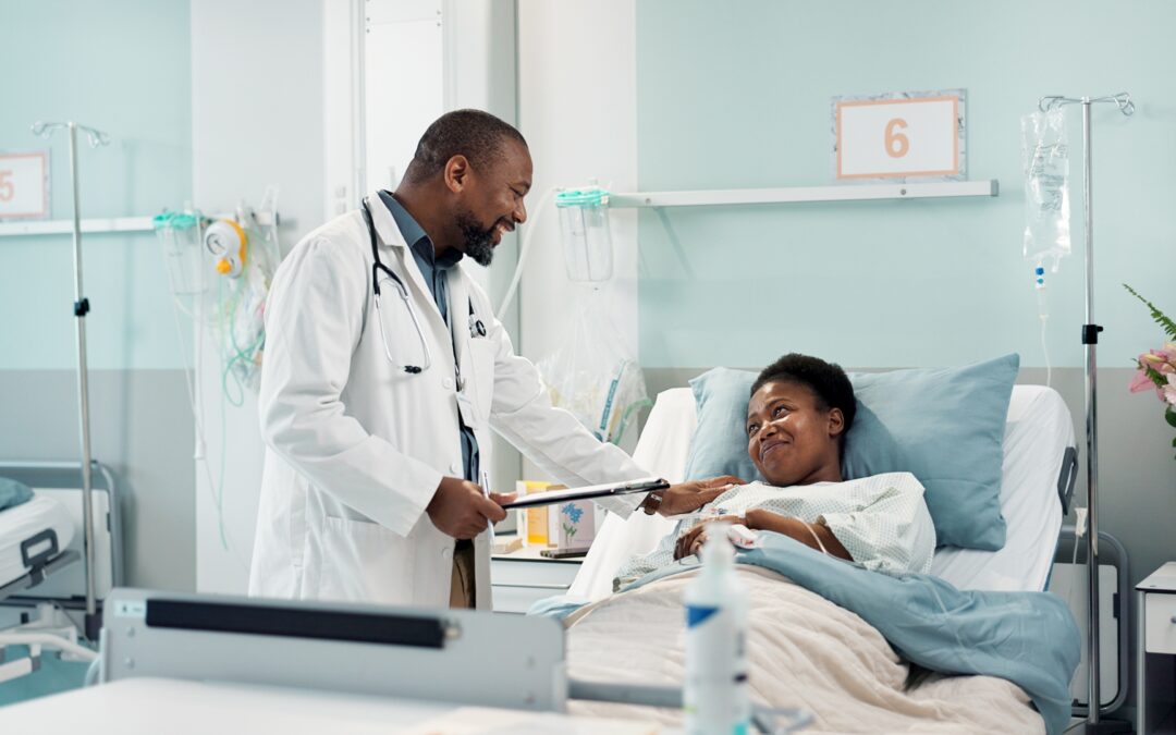 Doctor talking to patient following surgery.