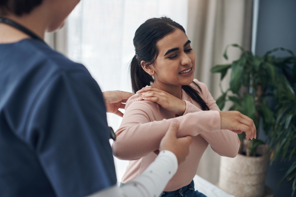 A woman discussing her pain with a doctor.