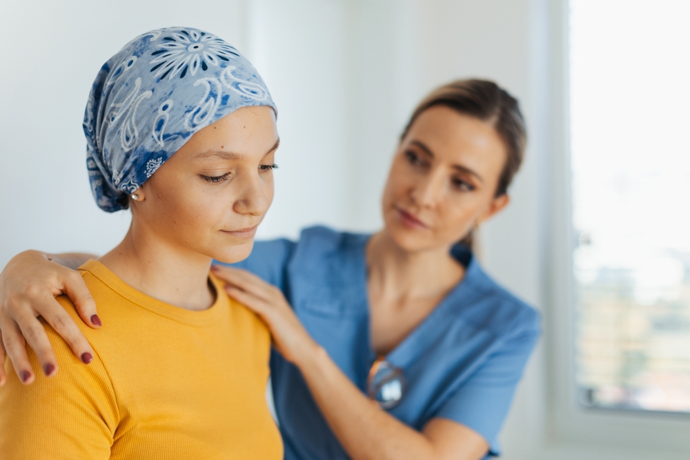 A nurse comforting a cancer patient.